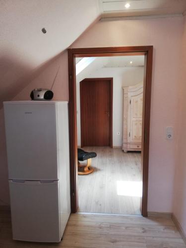 an attic room with a door leading into a room at Goslar Ferienwohnung im Harz in Neuwallmoden