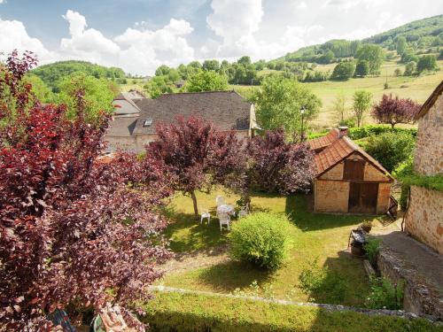 an aerial view of a garden with trees and a building at Tasteful Cottage in Roziers with Terrace in Lissac-sur-Couze