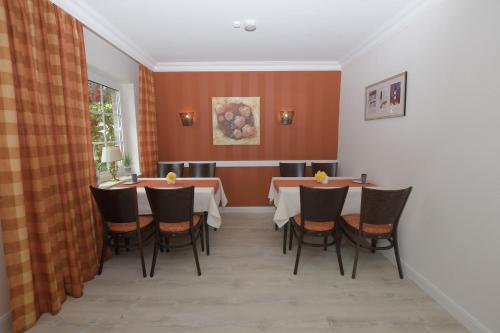 a dining room with a table and chairs at Hotel-Pension Achtern Diek in Büsum