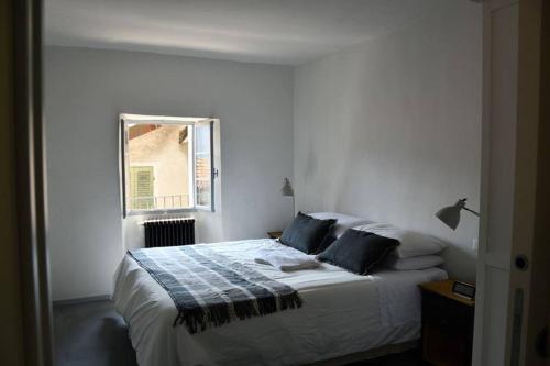 a bedroom with a bed and a window at Rocks apartment Colonno in Colonno