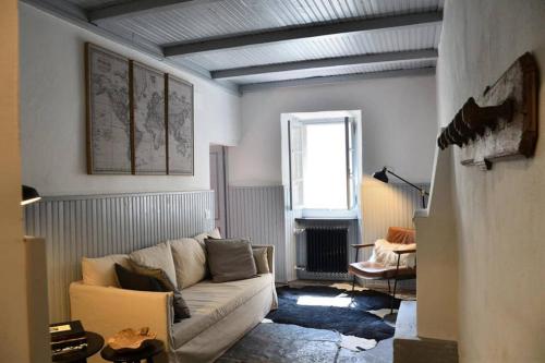 a living room with a couch and a window at Rocks apartment Colonno in Colonno