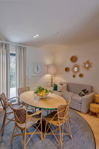 a living room with a table and chairs and a couch at Casa do Rio in Mondim de Basto