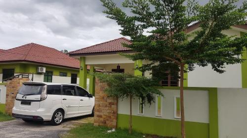 a white van parked in front of a house at PCB Homestay in Kota Bharu