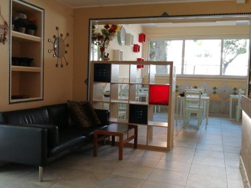 a living room with a black couch and a table at Hotel Brennero in Rimini