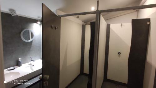 a bathroom with a sink and a toilet and a mirror at Gîte Le Chemin vers l'Etoile in Saint-Jean-Pied-de-Port