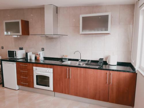 a kitchen with a sink and a counter top at OPORTO House AL in Maia