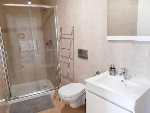 a bathroom with a toilet and a shower and a sink at OPORTO House AL in Maia