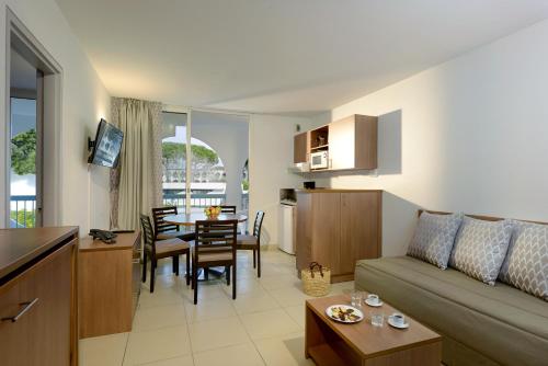 a living room and kitchen with a couch and a table at Residence Residéal La Grande Motte in La Grande Motte