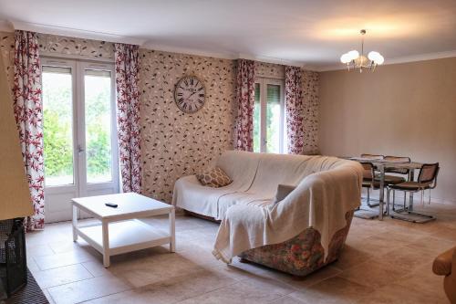a living room with a couch and a table at Villa piscine face au grand luberon Cereste in Céreste