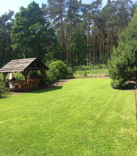 a gazebo in a yard with a grass field at Nad Wiartlem in Wiartel