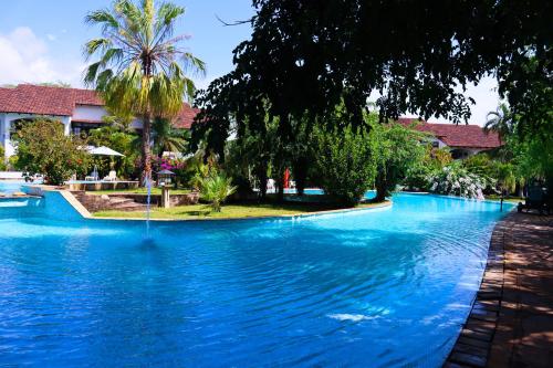 a swimming pool with blue water in a resort at Woburn Residence Club in Malindi