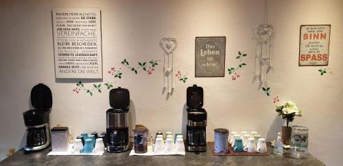 a counter with two black and white bottles on a wall at Zum Alten Schulhaus in Burg