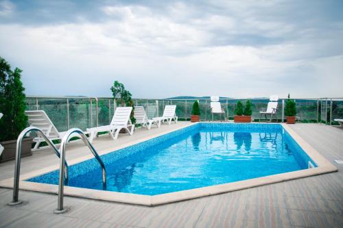 a swimming pool on the roof of a building at Holiday Apartment 7 in Hisarya