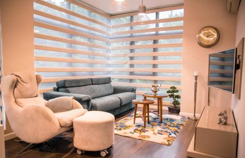 a living room with a couch and a chair at Holiday Apartment 7 in Hisarya