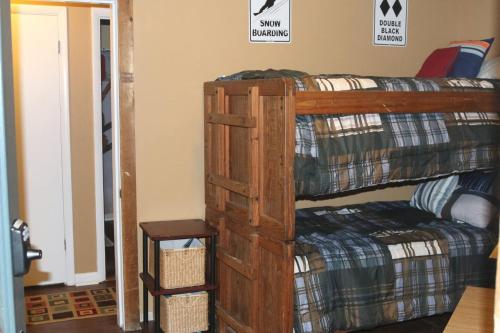 a bedroom with two bunk beds and a stool at Winterplace Condos - Ski In Ski Out! E101 in Ghent