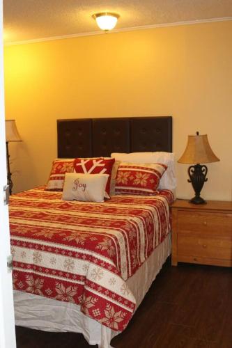 a bedroom with a bed with a red and white blanket at Winterplace Condos - Ski In Ski Out! E101 in Ghent
