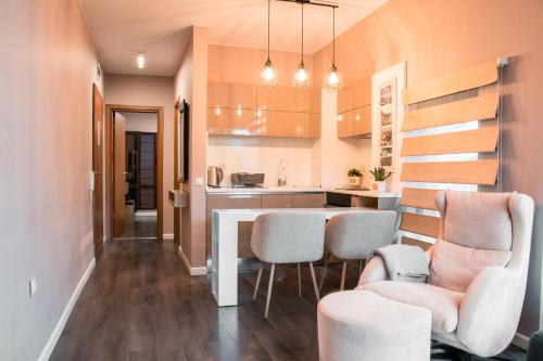 a kitchen with a table and chairs in a room at Holiday Apartment 7 in Hisarya