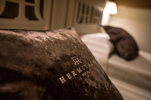 a close up of a pillow on a bed at Hotel Hermitage in Galatina