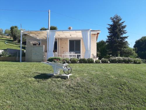 a small house with a bike in the grass at I Tre Laghi Countryhouse 14 posti letti Cottage 10 posti letti in Citta' Sant'Angelo