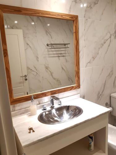 a bathroom with a sink and a mirror at BIG POSADAS in Concepción del Uruguay