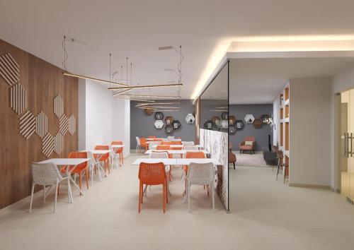 a room with tables, chairs, and tables in it at The Icons by TRIUS Hotels in Lisbon