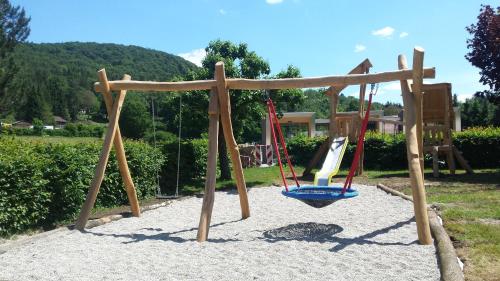 a playground with a swing in the sand at Hotel Lindenhof Hubmersberg in Pommelsbrunn