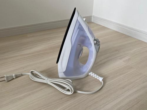 a computer monitor sitting on top of a floor at ホテルトーマス牧港ヴィラ in Urasoe