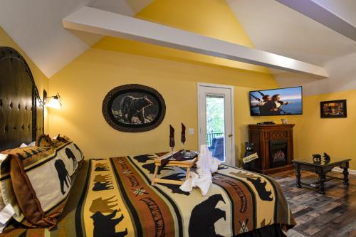 a bedroom with two beds and a flat screen tv at Mountain Romance in Gatlinburg
