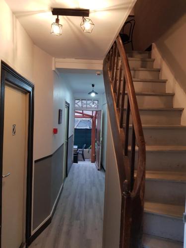 a hallway with stairs in a home with a stair case at Bar du Marché - Hôtel - Restaurant in Langeais