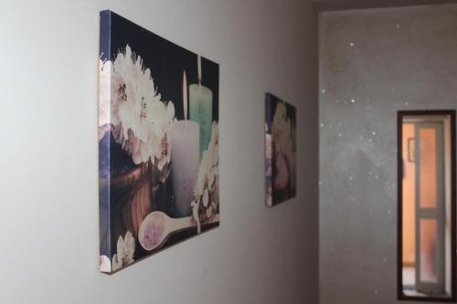 three pictures hanging on a wall in a room at Hotel Ristorante L'Avvenire in Gizzeria