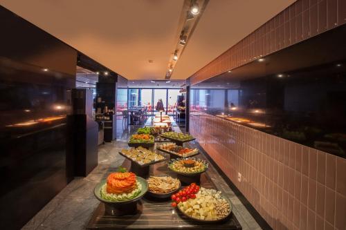 a buffet line with many different types of food at Hotel WZ Jardins in Sao Paulo