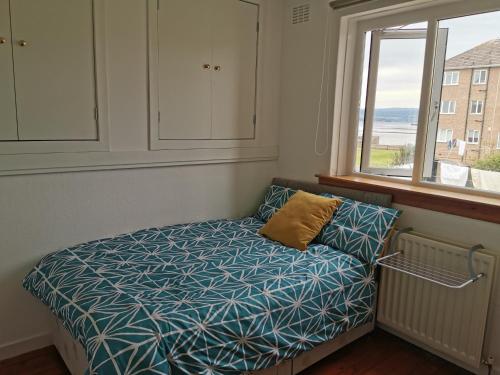 a small bedroom with a bed with a window at You deserve a staycation on the Firth of Clyde in Helensburgh