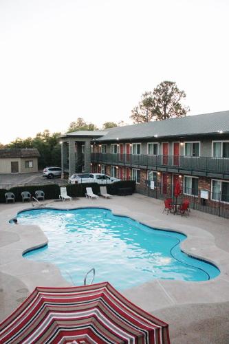 a large swimming pool in front of a building at Days Inn by Wyndham Show Low in Show Low
