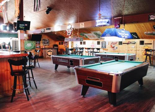a room with two pool tables and a bar at Days Inn by Wyndham Show Low in Show Low