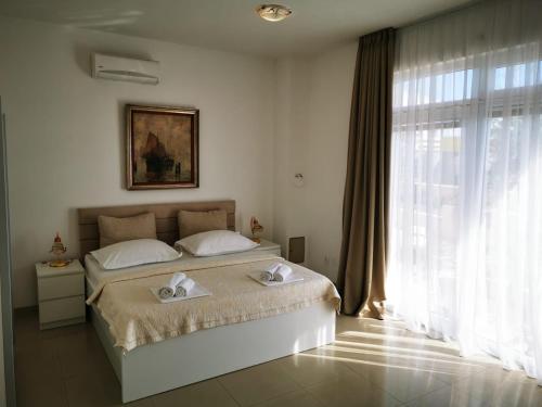 a bedroom with a bed and a large window at Apartment Marco in Makarska