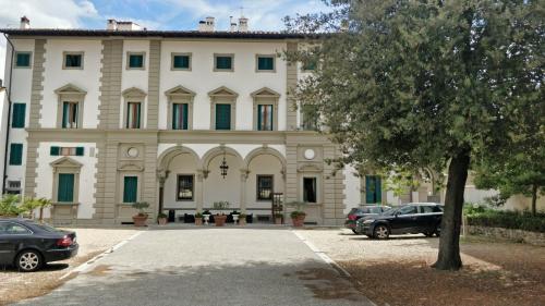 a large building with cars parked in front of it at Villa Royal in Florence