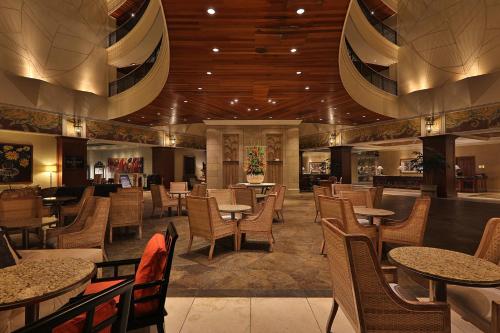 a restaurant with tables and chairs and a lobby at InterContinental Costa Rica at Multiplaza Mall by IHG in San José