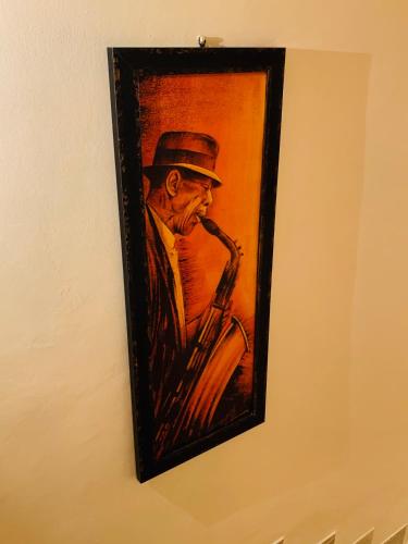 a painting of a man playing a saxophone at L'Arco B&B di Charme in Passignano sul Trasimeno