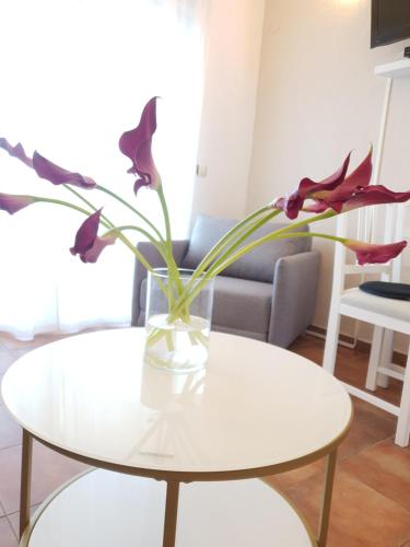 a vase with flowers sitting on a table at Apartments Habek in Vrboska