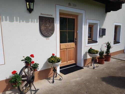 a front door of a building with potted plants at Ferienhaus Köck in Kartitsch