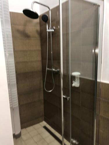 a shower with a glass door in a bathroom at Pensiunea SADA in Făgăraş