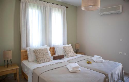 a bedroom with a large bed with towels on it at Althea Maisonettes in Áptera