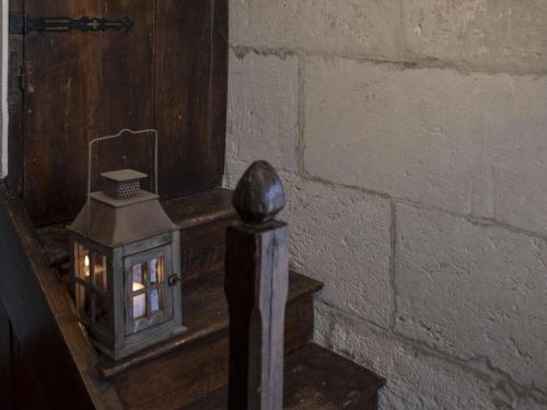 a small lantern sitting next to a brick wall at Le Boisdalon in Yviers