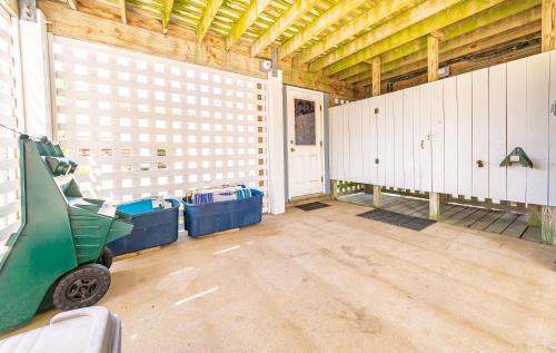 a garage with white walls and a green cart in it at Ocean View's in Kill Devil Hills