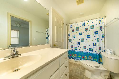 a bathroom with a sink and a toilet and a shower at Ocean View's in Kill Devil Hills
