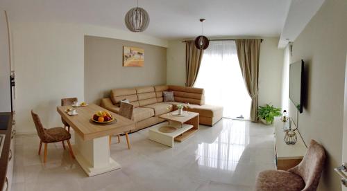a living room with a couch and a table at Ralux apartman Tivat in Tivat
