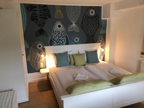 a bedroom with a large bed with a wall with eyes at Appartement 1 Baltic in Bergen auf Rügen