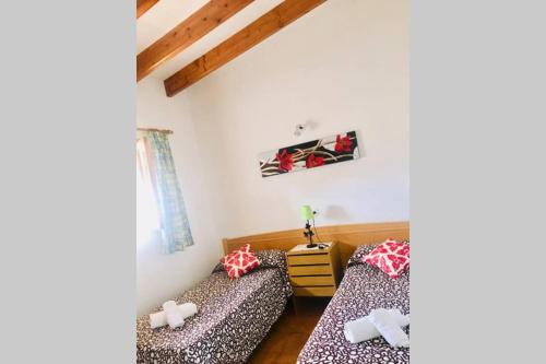 a room with two beds in a room at Casa Rural Es Cap de Barbaria Can Joan Guillem in Sant Francesc Xavier