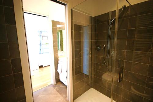 a bathroom with a shower with a glass door at LOFT BAYVIEW in Imperia