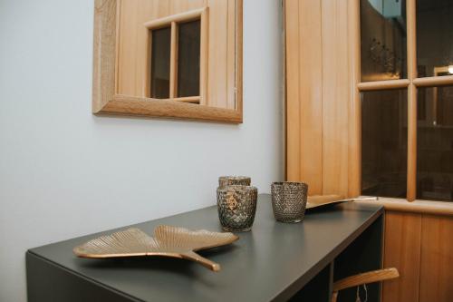 a kitchen counter with two cups and a cabinet at Apartma Metija LUX z savno in Kobarid